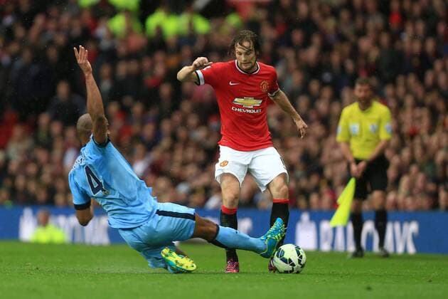Vincent Kompany of Manchester City goes in on Daley Blind of Manchester United ManU to earn a yellow card - Manchester United vs. Manchester City - Barclay s Premier League - Old Trafford - Manchester - 12 04 2015 Pic Philip Oldham Sportimage EDITORIAL USE ONLY. No use with unauthorised audio, video, data, fixture lists, club league logos or live services. Online in-match use limited to 120 images, no video emulation. No use in betting, games or single club league player publications.