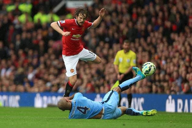 Vincent Kompany of Manchester City goes in on Daley Blind of Manchester United ManU to earn a yellow card - Manchester United vs. Manchester City - Barclay s Premier League - Old Trafford - Manchester - 12 04 2015 Pic Philip Oldham Sportimage EDITORIAL USE ONLY. No use with unauthorised audio, video, data, fixture lists, club league logos or live services. Online in-match use limited to 120 images, no video emulation. No use in betting, games or single club league player publications.