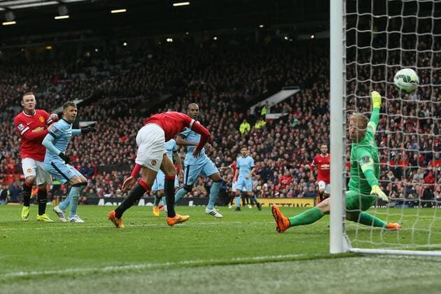 Chris Smalling of Manchester United ManU scores his sides fourth goal - Manchester United vs. Manchester City - Barclay s Premier League - Old Trafford - Manchester - 12 04 2015 Pic Philip Oldham Sportimage EDITORIAL USE ONLY. No use with unauthorised audio, video, data, fixture lists, club league logos or live services. Online in-match use limited to 120 images, no video emulation. No use in betting, games or single club league player publications.