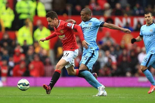 Ander Herrera of Manchester United ManU and Fernandinho of Manchester City - Manchester United vs. Manchester City - Barclay s Premier League - Old Trafford - Manchester - 12 04 2015 Pic Philip Oldham Sportimage EDITORIAL USE ONLY. No use with unauthorised audio, video, data, fixture lists, club league logos or live services. Online in-match use limited to 120 images, no video emulation. No use in betting, games or single club league player publications.