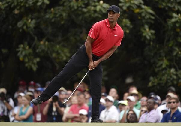 Tiger Woods leans on to one foot while he watches his putt on the first hole in the final round of the 2015 Masters Tournament at Augusta National Golf Club in Augusta, Georgia on April 12, 2015.  AUG20150412117 KEVINxDIETSCH
