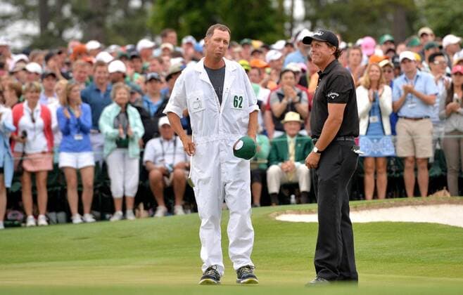 Phil Mickelson and caddie Jim Bones Mackay stand on the 18th green in the final round at the 2015 Masters Tournament at Augusta National Golf Club in Augusta, Georgia on April 12, 2015. Jordan Spieth won the 2015 Masters Tournament and it is his first major championship win with a score of 18 under par.  AUG20150412157 KEVINxDIETSCH