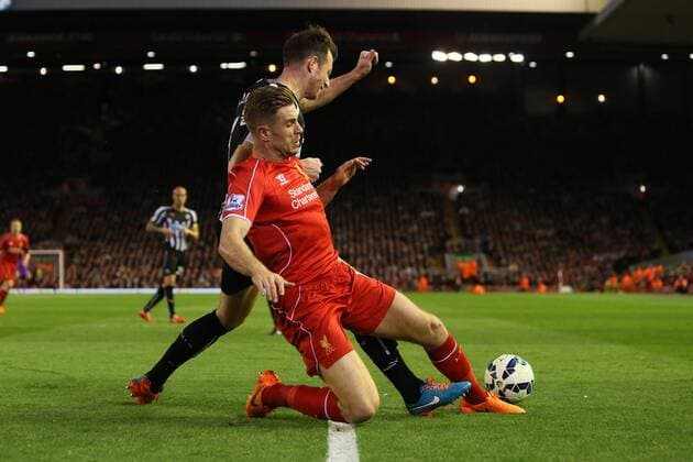Jordan Henderson of Liverpool tackles Mike Williamson of Newcastle United - Liverpool vs. Newcastle United - Barclay s Premier League - Anfield - Liverpool - 13 04 2015 Pic Philip Oldham Sportimage EDITORIAL USE ONLY. No use with unauthorised audio, video, data, fixture lists, club league logos or live services. Online in-match use limited to 120 images, no video emulation. No use in betting, games or single club league player publications.