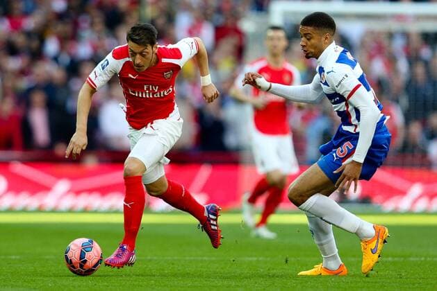 Mesut Ozil of Arsenal and Reading s Michael Hector - FA Cup Semi Final - Reading v Arsenal - Wembley Stadium - London - 18 04 2015 - Pic Charlie Forgham-Bailey Sportimage EDITORIAL USE ONLY. No use with unauthorised audio, video, data, fixture lists, club league logos or live services. Online in-match use limited to 120 images, no video emulation. No use in betting, games or single club league player publications.