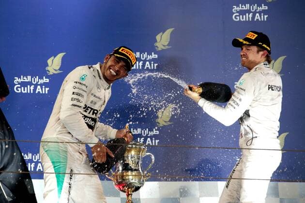 FORMULA 1 - Bahrain GP SAKHIR,BAHRAIN,19.APR.15 - MOTORSPORTS, FORMULA 1 - Grand Prix of Bahrain, Bahrain International Circuit, award ceremony. Image shows Lewis Hamilton (GBR Mercedes GP) and Nico Rosberg (GER Mercedes GP). Keywords: champagne shower, rosewater. GEPAxpictures xFritzxMueller 