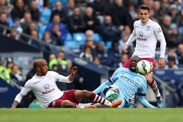 Fabian Delph of Aston Villa and Yaya Toure of Manchester City contest a loose ball - Manchester City vs. Aston Villa - Barclay s Premier League - Etihad Stadium - Manchester - 25 04 2015 Pic Philip Oldham Sportimage EDITORIAL USE ONLY. No use with unauthorised audio, video, data, fixture lists, club league logos or live services. Online in-match use limited to 120 images, no video emulation. No use in betting, games or single club league player publications.