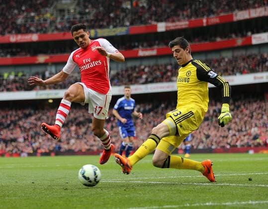 Arsenal s Alexis Sanchez tussles with Chelsea s Thibaut Courtois Barclays Premier League - Arsenal vs Chelsea - Emirates Stadium - England - 26th April 2015 - Picture David Klein Sportimage EDITORIAL USE ONLY. No use with unauthorised audio, video, data, fixture lists, club league logos or live services. Online in-match use limited to 120 images, no video emulation. No use in betting, games or single club league player publications.