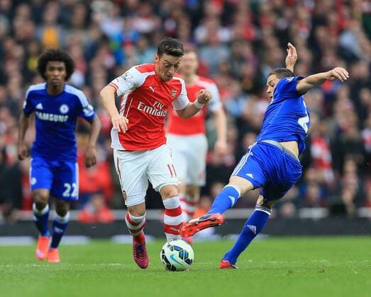 Arsenal s Mesut Ozil tussles with Chelsea s Nemanja Matic Barclays Premier League - Arsenal vs Chelsea - Emirates Stadium - England - 26th April 2015 - Picture David Klein Sportimage EDITORIAL USE ONLY. No use with unauthorised audio, video, data, fixture lists, club league logos or live services. Online in-match use limited to 120 images, no video emulation. No use in betting, games or single club league player publications.