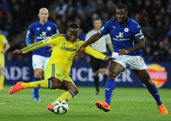 Football - 2014 2015 Premier League - Leicester City vs. Chelsea Didier Drogba of Chelsea and Wes Morgan of Leicester at the King Power Stadium. COLORSPORT ANDREW COWIE 
