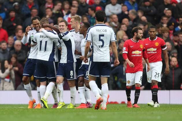 West Brom s Chris Brunt is mobbed by team mates following his opening goal - Manchester United ManU vs. West Bromwich Albion - Barclay s Premier League - Old Trafford - Manchester - 02 05 2015 Pic Philip Oldham Sportimage EDITORIAL USE ONLY. No use with unauthorised audio, video, data, fixture lists, club league logos or live services. Online in-match use limited to 120 images, no video emulation. No use in betting, games or single club league player publications.