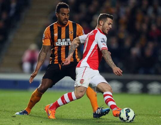 Jack Wilshere of Arsenal goes past Tom Huddlestone of Hull City - Barclays Premier League - Hull City vs Arsenal - KC Stadium - Hull - England - 4th May 2015 - Picture Simon Bellis Sportimage EDITORIAL USE ONLY. No use with unauthorised audio, video, data, fixture lists, club league logos or live services. Online in-match use limited to 120 images, no video emulation. No use in betting, games or single club league player publications.