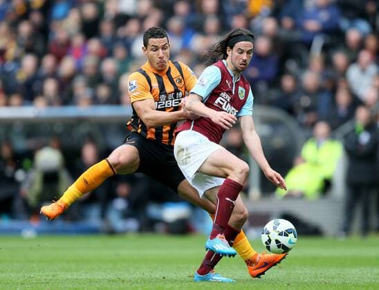 Jake Livermore of Hull City challenges George Boyd of Burnley - Barclays Premier League - Hull City vs Burnley - KC Stadium - Hull - England - 9th May 2015 - Picture Simon Bellis Sportimage EDITORIAL USE ONLY. No use with unauthorised audio, video, data, fixture lists, club league logos or live services. Online in-match use limited to 120 images, no video emulation. No use in betting, games or single club league player publications.
