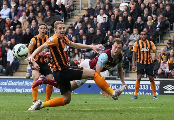 Ashley Barnes of Burnley gets ahead of Michael Dawson of Hull City only to fail to connect with the ball - Barclays Premier League - Hull City vs Burnley - KC Stadium - Hull - England - 9th May 2015 - Picture Simon Bellis Sportimage EDITORIAL USE ONLY. No use with unauthorised audio, video, data, fixture lists, club league logos or live services. Online in-match use limited to 120 images, no video emulation. No use in betting, games or single club league player publications.