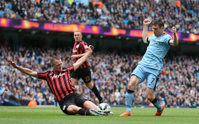 James Milner of Manchester City is tackled by Clint Hill of QPR - Barclays Premier League - Manchester City vs QPR - Etihad Stadium - Manchester - England - 10th May 2015 - Picture Simon Bellis Sportimage EDITORIAL USE ONLY. No use with unauthorised audio, video, data, fixture lists, club league logos or live services. Online in-match use limited to 120 images, no video emulation. No use in betting, games or single club league player publications.