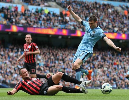 Aktuell Fußball, England, Manchester City - Queens Park Rangers James Milner of Manchester City is tackled by Clint Hill of QPR - Barclays Premier League - Manchester City vs QPR - Etihad Stadium - Manchester - England - 10th May 2015 - Picture Simon Bellis Sportimage EDITORIAL USE ONLY. No use with unauthorised audio, video, data, fixture lists, club league logos or live services. Online in-match use limited to 120 images, no video emulation. No use in betting, games or single club league player publications.