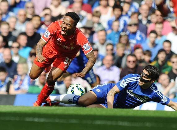 Football - 2014 2015 Premier League - Chelsea vs. Liverpool Raheem Sterling of Liverpool is fouled by Cesc Fabregas at Stamford Bridge. COLORSPORT ANDREW COWIE 