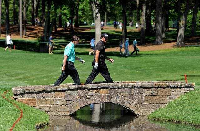 May 13, 2015 - Charlotte, NC, USA - Golf - - Phil Mickelson, right, and Brian Leary, left, walk across a bridge on the 18th fairway during the Pro-Am on Wednesday, May 13, 2015, at Quail Hollow Club in Charlotte, N.C. Wells Fargo Pro-Am round - ZUMAm67_