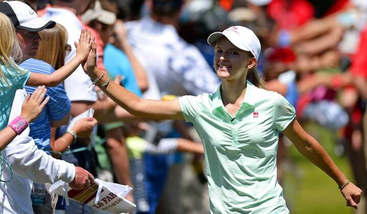 May 13, 2015 - Charlotte, NC, USA - Grace Vaughan high fives fans as she walks to the fifth tee box during the Pro-Am on Wednesday, May 13, 2015, at Quail Hollow Club in Charlotte, N.C. Vaughan, from Spartanburg, S.C., was the winner of an essay contest and was part of PGA Golf Herren player Rory McIlroy s team during the Pro-Am. Wells Fargo Pro-Am round - ZUMAm67_