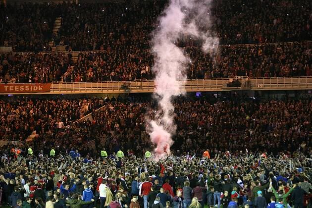 A smoke bomb is let off as fans invade the pitch - Middlesbrough vs. Brentford - Skybet Championship - Play Off Second Leg - Riverside Stadium - Middlesbrough - 15 05 2015 Pic Philip Oldham Sportimage EDITORIAL USE ONLY. No use with unauthorised audio, video, data, fixture lists, club league logos or live services. Online in-match use limited to 120 images, no video emulation. No use in betting, games or single club league player publications.