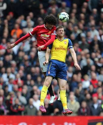 Manchester United ManU s Marouane Fellaini catches Arsenal s Per Mertesacker with an elbow Barclays Premier League - Manchester United vs Arsenal - Old Trafford - England - 17th May 2015 - Picture David Klein Sportimage EDITORIAL USE ONLY. No use with unauthorised audio, video, data, fixture lists, club league logos or live services. Online in-match use limited to 120 images, no video emulation. No use in betting, games or single club league player publications.