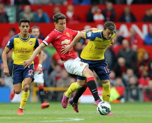 Manchester United ManU s Ander Herrera tussles with Arsenal s Mesut Ozil Barclays Premier League - Manchester United vs Arsenal - Old Trafford - England - 17th May 2015 - Picture David Klein Sportimage EDITORIAL USE ONLY. No use with unauthorised audio, video, data, fixture lists, club league logos or live services. Online in-match use limited to 120 images, no video emulation. No use in betting, games or single club league player publications.