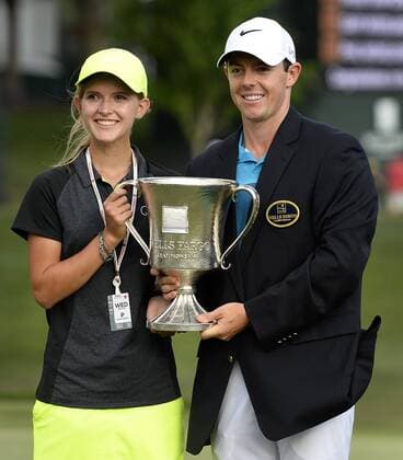 May 17, 2015 - Charlotte, NC, USA - Rory McIlroy with Grace Vaughan, left, holds the Wells Fargo Championship trophy after winning the tournament on Sunday, May 17, 2015, at Quail Hollow Club in Charlotte, N.C. Vaughan played in the tournament s pro-am with McIlroy earlier in the week. Wells Fargo Championship, final round - ZUMAm67_