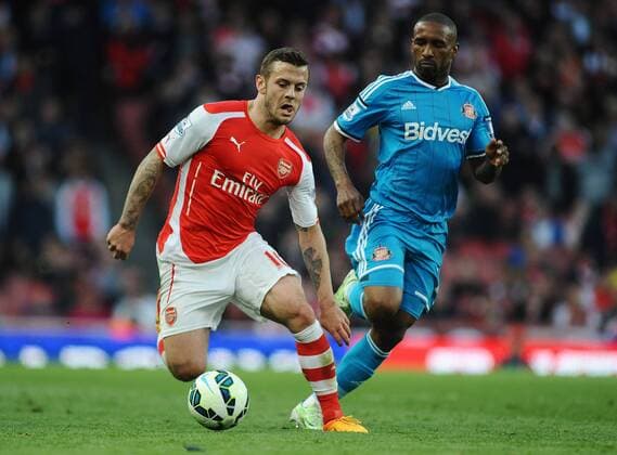 Football - 2014 2015 Premier League Arsenal v Sunderland Jack Wilshire of Arsenal and Jermain Defoe at the Emirates stadium COLORSPORT ANDREW COWIE 
