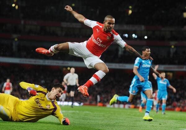 Football - 2014 2015 Premier League Arsenal v Sunderland Theo Walcott of Arsenal flies over the top of Costel Pantilimon at the Emirates stadium COLORSPORT ANDREW COWIE 