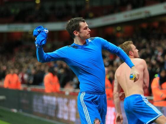 Sunderland s Adam Johnson celebrates at the final whistle by throwing his shirt into the crowd Barclays Premier League - Arsenal vs Sunderland - Emirates Stadium - England - 20th May 2015 - Picture David Klein Sportimage EDITORIAL USE ONLY. No use with unauthorised audio, video, data, fixture lists, club league logos or live services. Online in-match use limited to 120 images, no video emulation. No use in betting, games or single club league player publications.