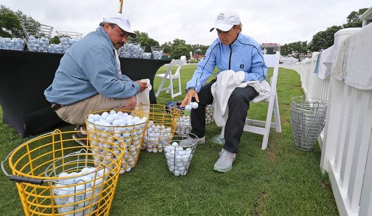 May 21, 2015 - Fort Worth, TX, USA - First Tee of Fort Worth workers Jorge Croda, left, and Heather Young wipe down all of the practice chipping green golf balls used by the pros after rains soaked Colonial grounds the morning of the first day of competition at the Crowne Plaza Invitational at Colonial on May 21, 2015 in Fort Worth, Texas. Crowne Plaza Invitational golf - ZUMAm67_