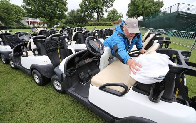 May 21, 2015 - Fort Worth, TX, USA - Tournament staff member Randy Garms begins to wipe down golf carts used by the pros to get to the driving range after rains soaked Colonial grounds the morning of the first day of competition at the Crowne Plaza Invitational at Colonial on May 21, 2015 in Fort Worth, Texas. Crowne Plaza Invitational golf - ZUMAm67_