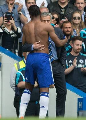 Football - 2014 2015 Premier League - Chelsea vs. Sunderland. José Mourinho, Manager, of Chelsea FC hugs Chelsea s Didier Drogba as he leaves the pitch on his last appearance for Chelsea at Stamford Bridge COLORSPORT DANIEL BEARHAM  CHE_SUN