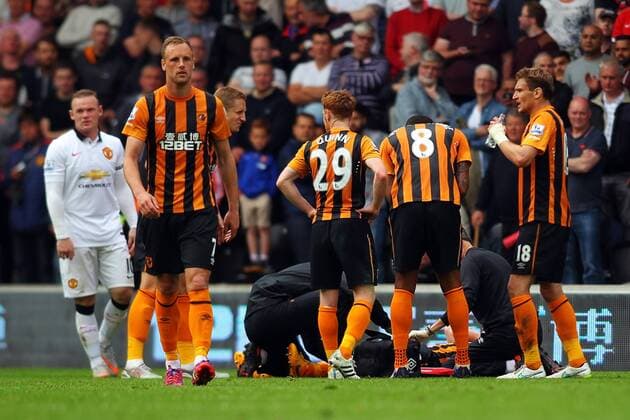 24.05.2015. Hull, England. Barclays Premier League. Hull versus Manchester United ManU Paul McShane of Hull City receives treatment following his injuryi. Marouane Fellaini of Manchester United is shown the red card and sent off xPaulxKeevilx  ActionPlus11623796