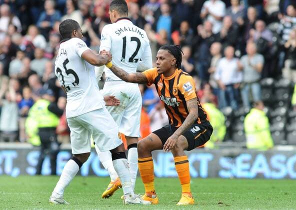 Football - 2014 2015 Premier League - Hull City vs. Manchester United ManU Abel Hernandez of Hull is helped to his feet by Valencia after breaking down in tears at the final whistle after being relegated at KC Stadium. COLOSPORT ANDREW COWIE 