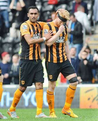Football - 2014 2015 Premier League - Hull City vs. Manchester United ManU Paul McShane of Hull in consoled by Ahmed Elmohamady at the final whistle after being relegated at KC Stadium. COLOSPORT ANDREW COWIE 