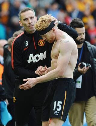 Football - 2014 2015 Premier League - Hull City vs. Manchester United ManU Paul McShane of Hull in consoled by a United Official after being relegated at KC Stadium. COLOSPORT ANDREW COWIE 