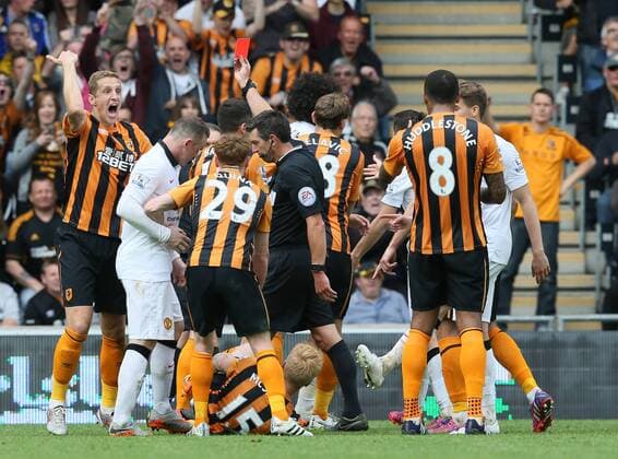 Mauroane Fellaini of Manchester United ManU is red carded as Michael Dawson of Hull City shouts for the trainers to come on for an injured Paul McShane of Hull City - Barclays Premier League - Hull City vs Manchester Utd - KC Stadium - Hull - England - 24th May 2015 - Picture Simon Bellis Sportimage EDITORIAL USE ONLY. No use with unauthorised audio, video, data, fixture lists, club league logos or live services. Online in-match use limited to 120 images, no video emulation. No use in betting, games or single club league player publications.
