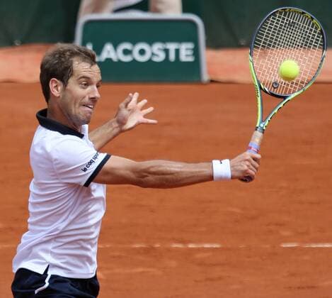 Richard Gasquet of France hits a shot during his French Open men s second round match against Carlos Berlocq of Argentina at Roland Garros in Paris on May 29, 2015. Gasquet defeated Berlocq 3-6, 6-3, 6-1, 4-6, 6-1 to advance to the next round.  PAR20150529717 DAVIDxSILPA