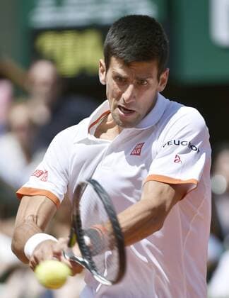 Novak Djokovic of Serbia returns a short during a French Open third round match on May 30, 2015, in Paris 