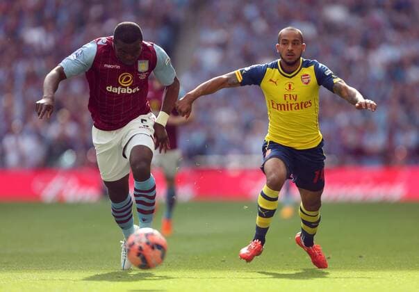 Jores Okore of Aston Villa battles Arsenal s Theo Walcott - Arsenal vs. Aston Villa - FA Cup Final - Wembley Stadium - London - 30 05 2015 Pic Philip Oldham Sportimage EDITORIAL USE ONLY. No use with unauthorised audio, video, data, fixture lists, club league logos or live services. Online in-match use limited to 120 images, no video emulation. No use in betting, games or single club league player publications.
