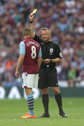 Tom Cleverley of Aston Villa earns a yellow card for his tackle on Arsenal s Nacho Monreal - Arsenal vs. Aston Villa - FA Cup Final - Wembley Stadium - London - 30 05 2015 Pic Philip Oldham Sportimage EDITORIAL USE ONLY. No use with unauthorised audio, video, data, fixture lists, club league logos or live services. Online in-match use limited to 120 images, no video emulation. No use in betting, games or single club league player publications.