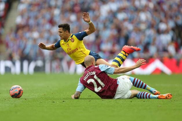 Alan Hutton of Aston Villa puts in a challenge on Arsenal s Alexis Sanchez - Arsenal vs. Aston Villa - FA Cup Final - Wembley Stadium - London - 30 05 2015 Pic Philip Oldham Sportimage EDITORIAL USE ONLY. No use with unauthorised audio, video, data, fixture lists, club league logos or live services. Online in-match use limited to 120 images, no video emulation. No use in betting, games or single club league player publications.