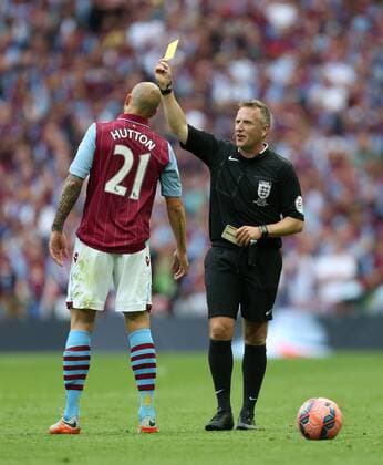 Alan Hutton of Aston Villa is shown a yellow card by referee Jon Moss - Arsenal vs. Aston Villa - FA Cup Final - Wembley Stadium - London - 30 05 2015 Pic Philip Oldham Sportimage EDITORIAL USE ONLY. No use with unauthorised audio, video, data, fixture lists, club league logos or live services. Online in-match use limited to 120 images, no video emulation. No use in betting, games or single club league player publications.