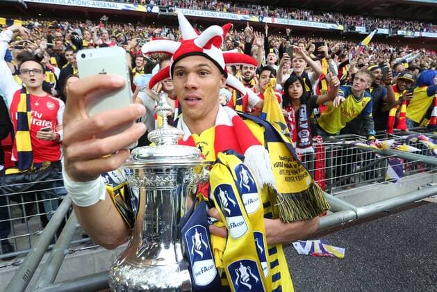 Arsenal s Kieran Gibbs poses for a selfie with the FA Cup - Arsenal vs. Aston Villa - FA Cup Final - Wembley Stadium - London - 30 05 2015 Pic Philip Oldham Sportimage EDITORIAL USE ONLY. No use with unauthorised audio, video, data, fixture lists, club league logos or live services. Online in-match use limited to 120 images, no video emulation. No use in betting, games or single club league player publications.