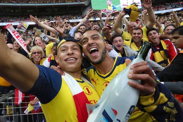 Alex Oxlade-Chamberlain and Theo Walcott of Arsenal pose for selfies with fans - Arsenal vs. Aston Villa - FA Cup Final - Wembley Stadium - London - 30 05 2015 Pic Philip Oldham Sportimage EDITORIAL USE ONLY. No use with unauthorised audio, video, data, fixture lists, club league logos or live services. Online in-match use limited to 120 images, no video emulation. No use in betting, games or single club league player publications.