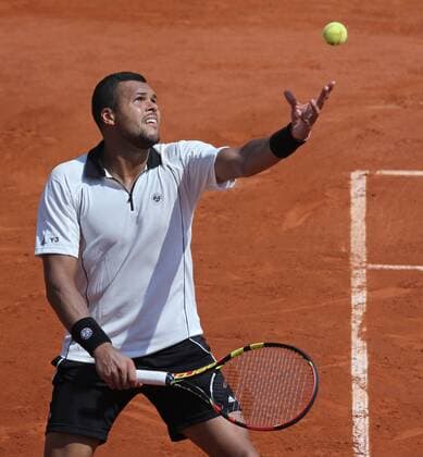 Jo-Wilfried Tsonga of France hits a serve during his French Open men s semifinal match against Stan Wawrinka of Switzerland at Roland Garros in Paris on June 5, 2015.  PAR20150605725 DAVIDxSILPA