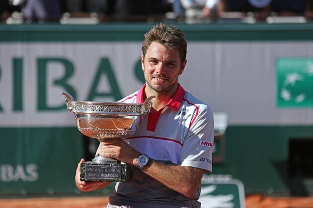 Stan Wawrinka of Switzerland holds the championship trophy after winning his French Open men s final match against Novak Djokovic of Serbia at Roland Garros in Paris on June 7, 2015. Wawrinka defeated Djokovic 4-6, 6-4, 6-3, 6-4 to win his first French Open championship.  PAR20150607714 DAVIDxSILPA