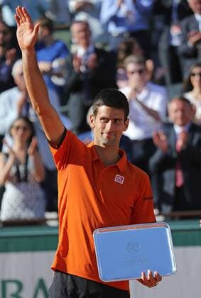 Novak Djokovic of Serbia holds the runners-up trophy after losing his French Open men s final match against Stan Wawrinka of Switzerland at Roland Garros in Paris on June 7, 2015. Wawrinka defeated Djokovic 4-6, 6-4, 6-3, 6-4 to win his first French Open championship.  PAR20150607724 DAVIDxSILPA