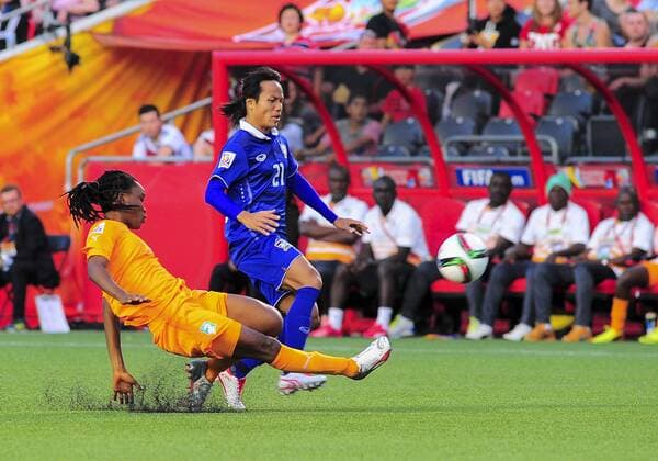 June 11, 2015 - Ottawa, Ontario, Canada - June 11, 2015: Defender Fatou Coulibaly ( 2) of Câ ¢te dÃ Ivoire slides in on midfielder Kanjana Sung-Ngoen ( 21) of Thailand during the FIFA 2015 Women s World Cup Group B match between Câ ¢te dÃ Ivoire and Thailand, which Thailand won 3-2 at Lansdowne Park in Ottawa, Canada. Soccer: FIFA 2015 Women s World Cup Group B Match - C™te dÕIvoire versus Thailand. - ZUMAk120