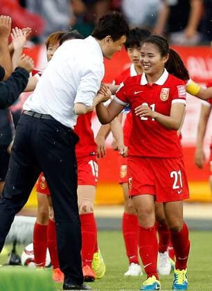 EDMONTON, June 11, 2015 -- Wang Lisi (R) of China shakes hands with Hao Wei, head coach of China, after winning a group A match against the Netherlands at the 2015 FIFA Women s World Cup in Edmonton, Canada, June 11, 2015.China won 1-0. ) (SP)CANADA-EDMONTON-FIFA-WOMEN S WORLD CUP-GROUP A-CHN VS NED WangxLili 